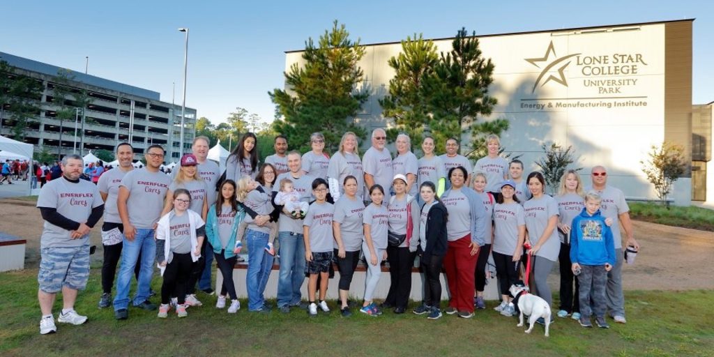 Group of people in Enerflex Cares shirts posing at Lone Star College University Park, Energy & Manufacturing Institute