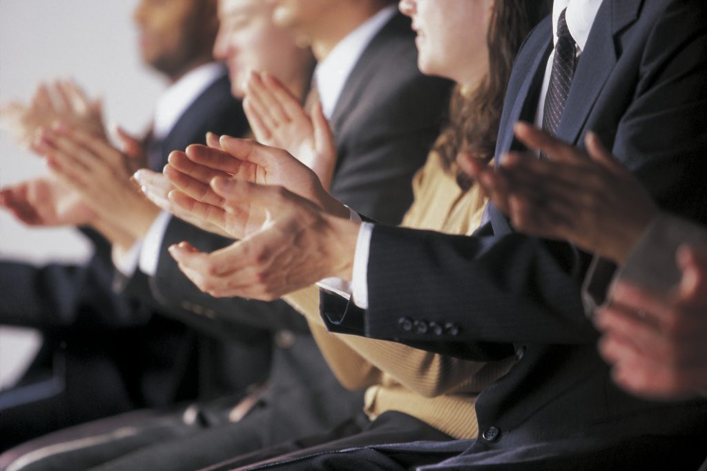 A diverse group of business people applauding